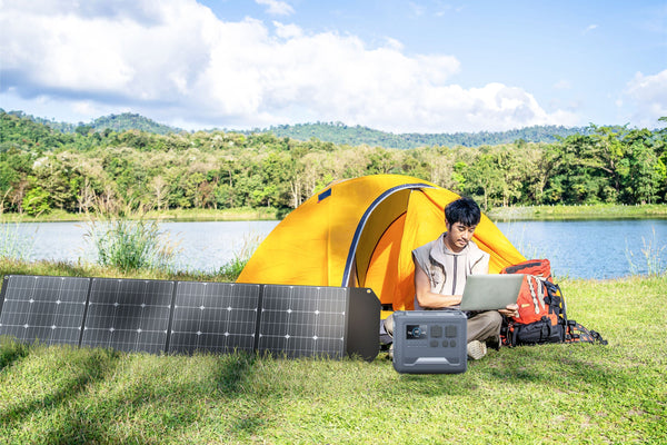 iFORWAY portable power station charging with a 4-fold solar panel during an off-grid camping trip